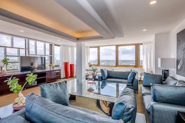 a living room with couches and a glass table