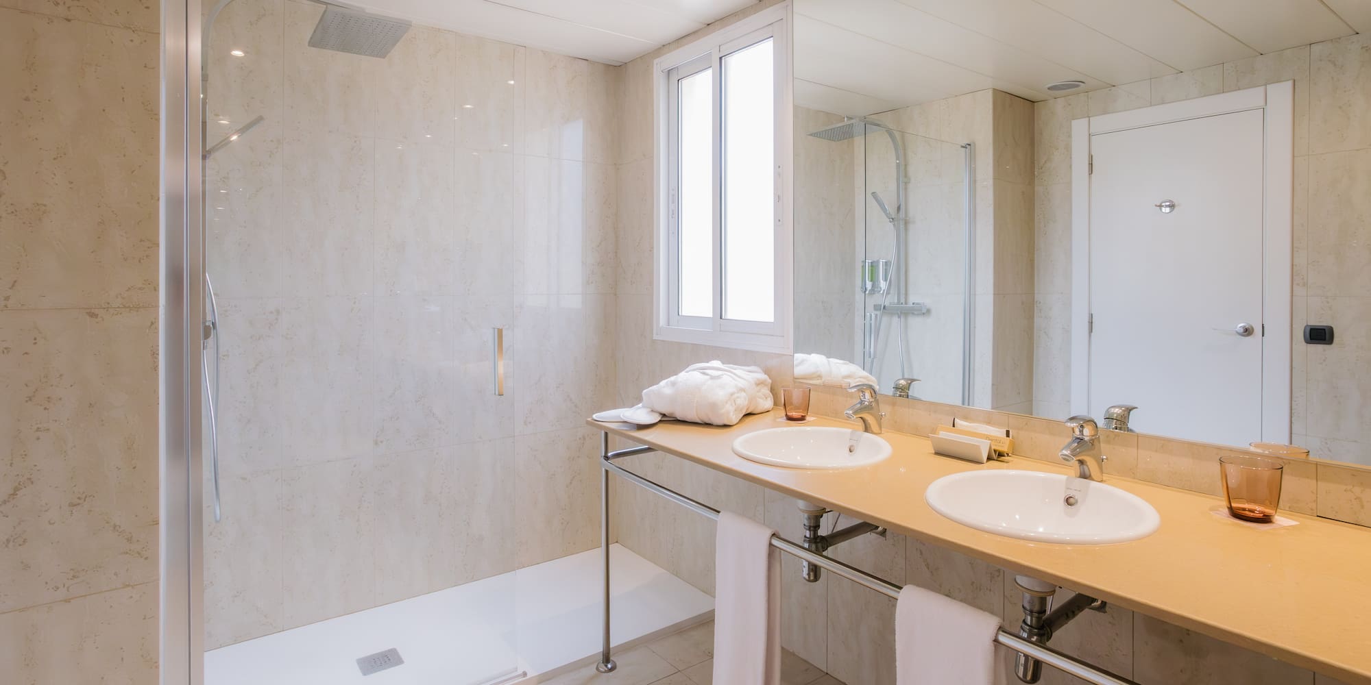 a bathroom with a shower and two sinks