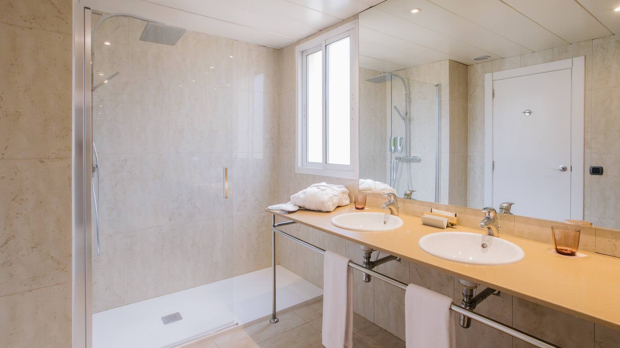 a bathroom with a shower and two sinks