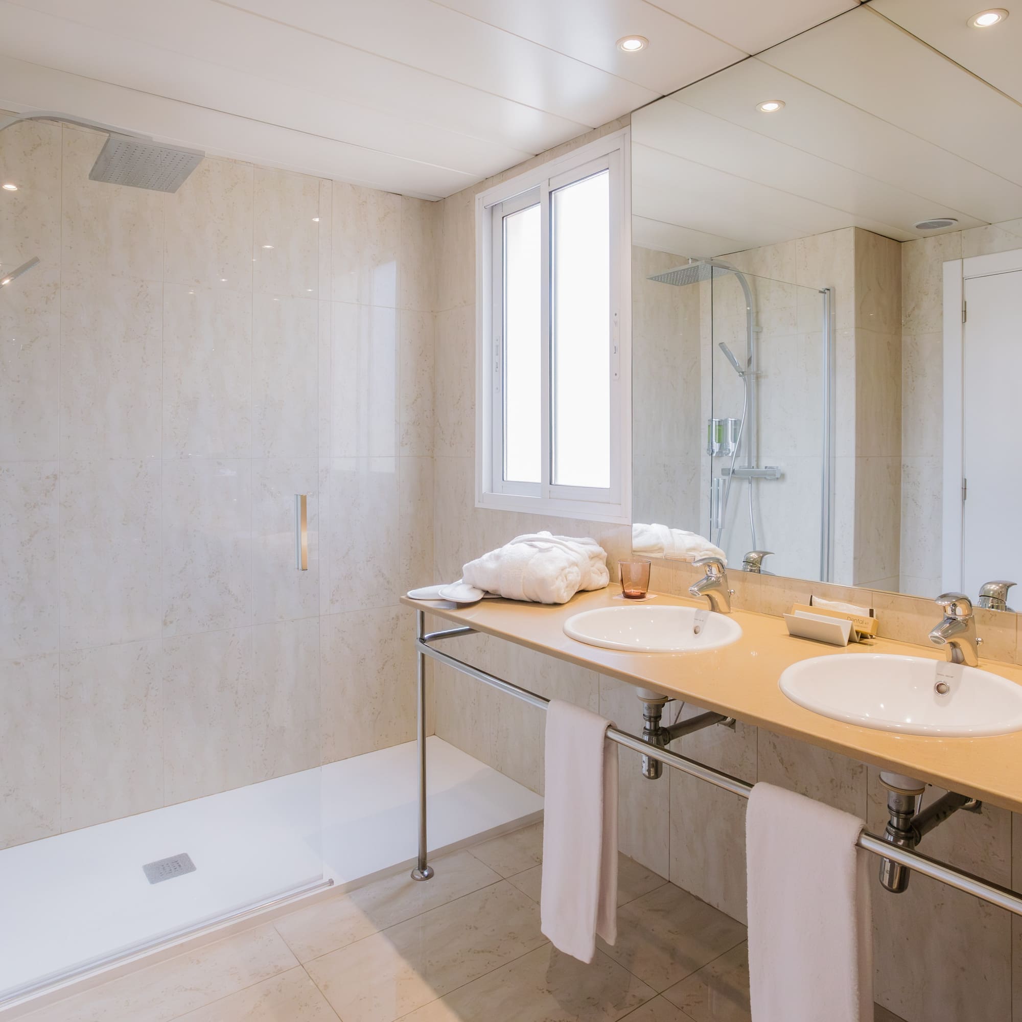 a bathroom with a shower and two sinks