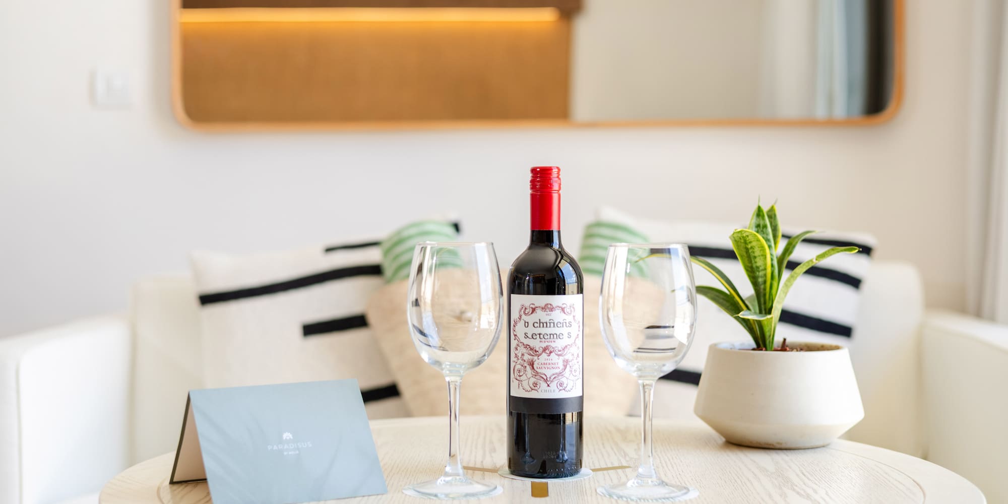 a wine bottle and wine glasses on a table