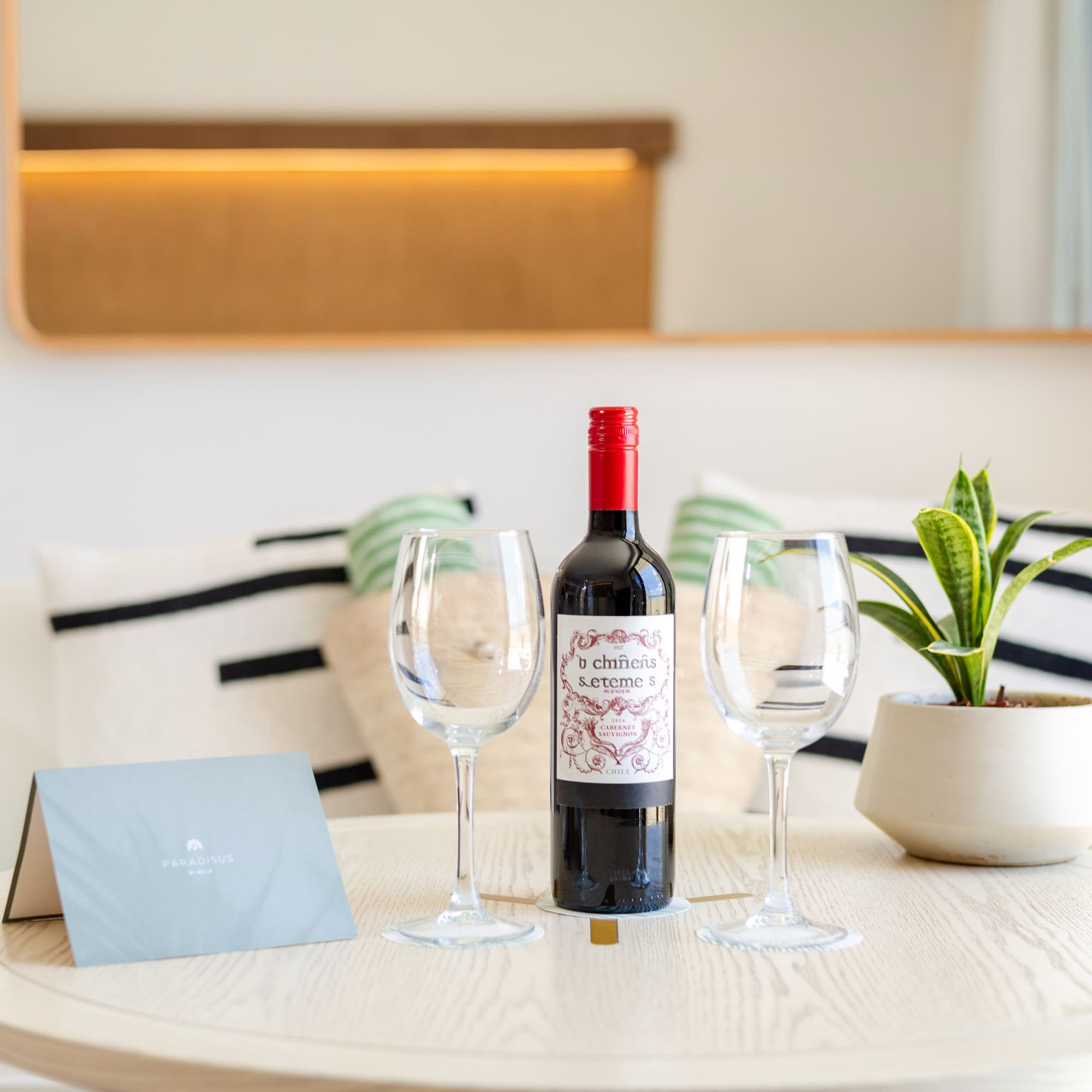 a wine bottle and wine glasses on a table