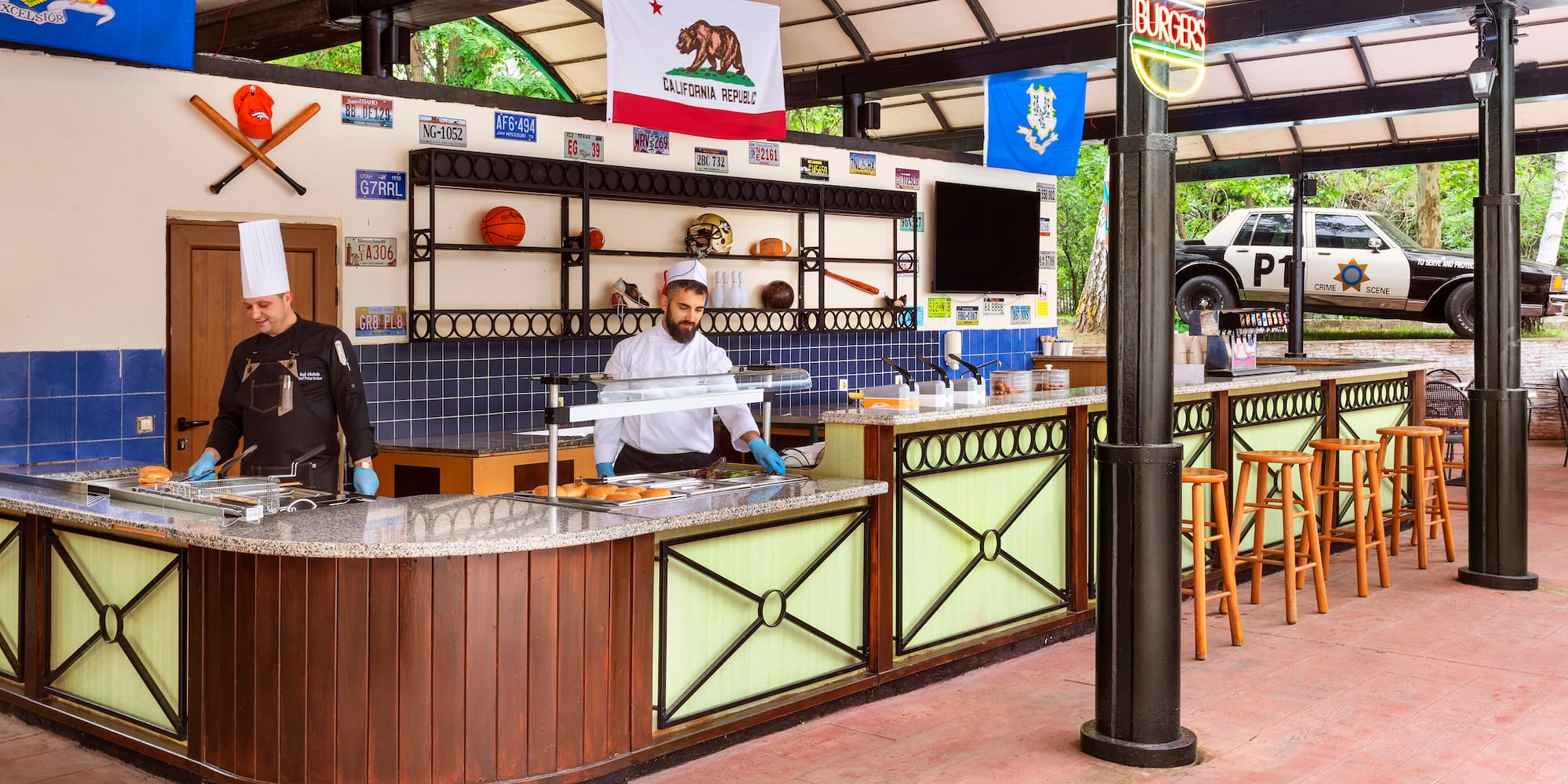 two men in chefs hats behind a counter