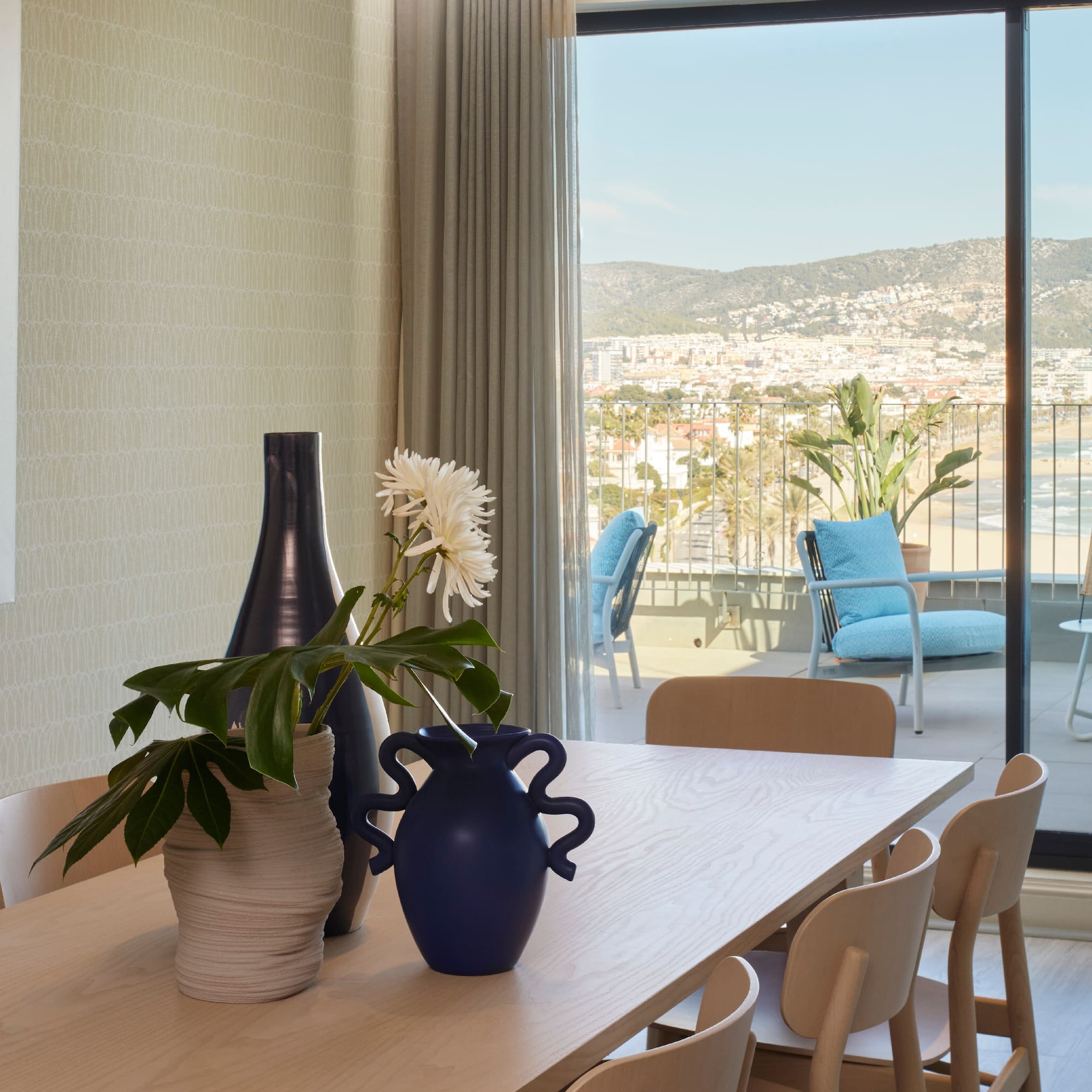 a table with chairs and vases on it