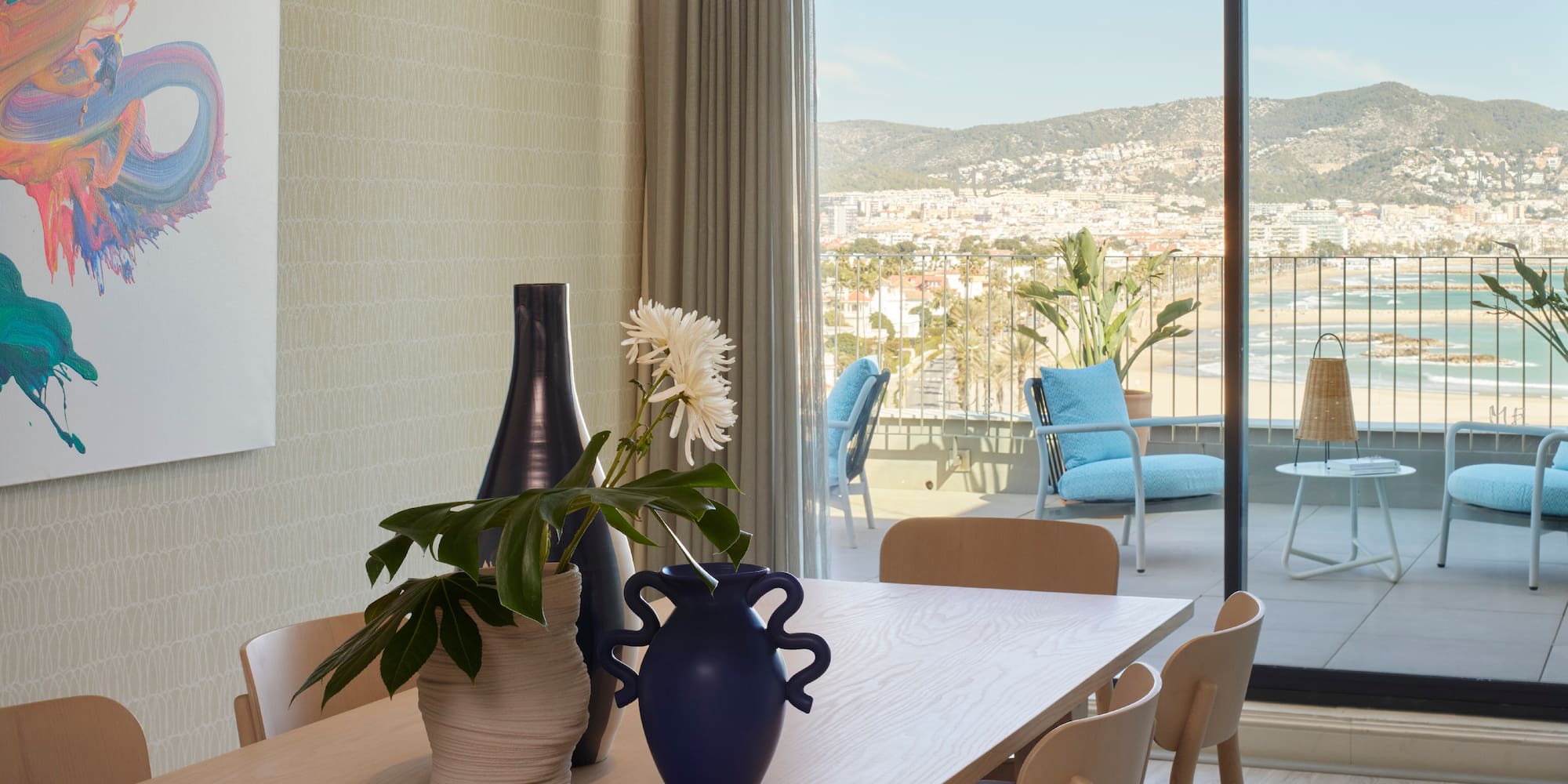 a table with chairs and vases on it