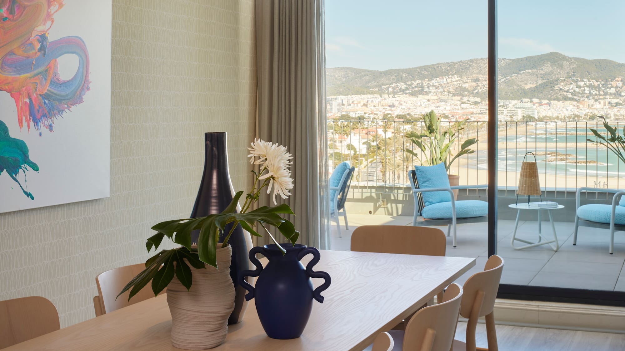 a table with chairs and vases on it
