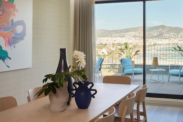 a table with chairs and vases on it