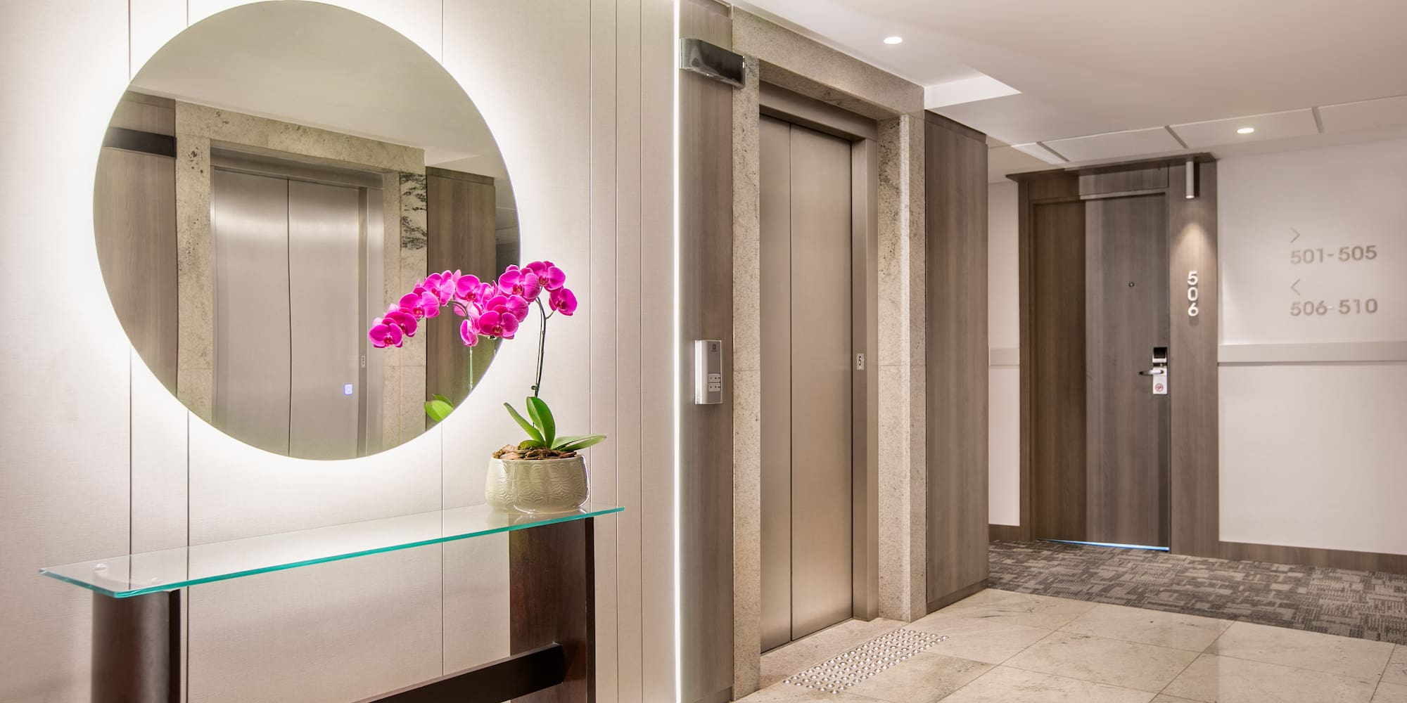 a mirror in a hallway with elevator doors