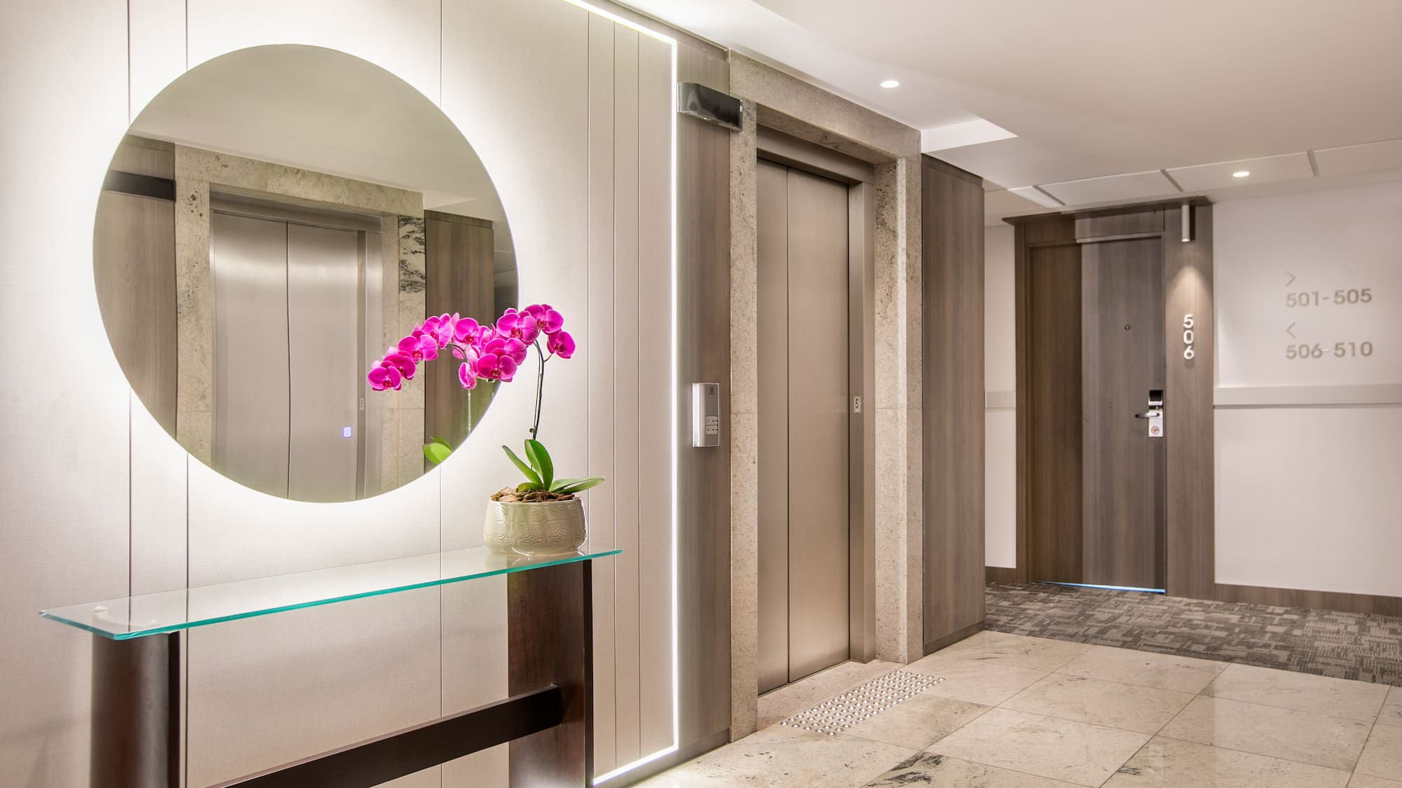 a mirror in a hallway with elevator doors