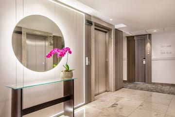 a mirror in a hallway with elevator doors