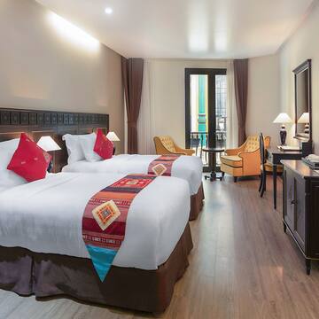a room with two beds and a dresser