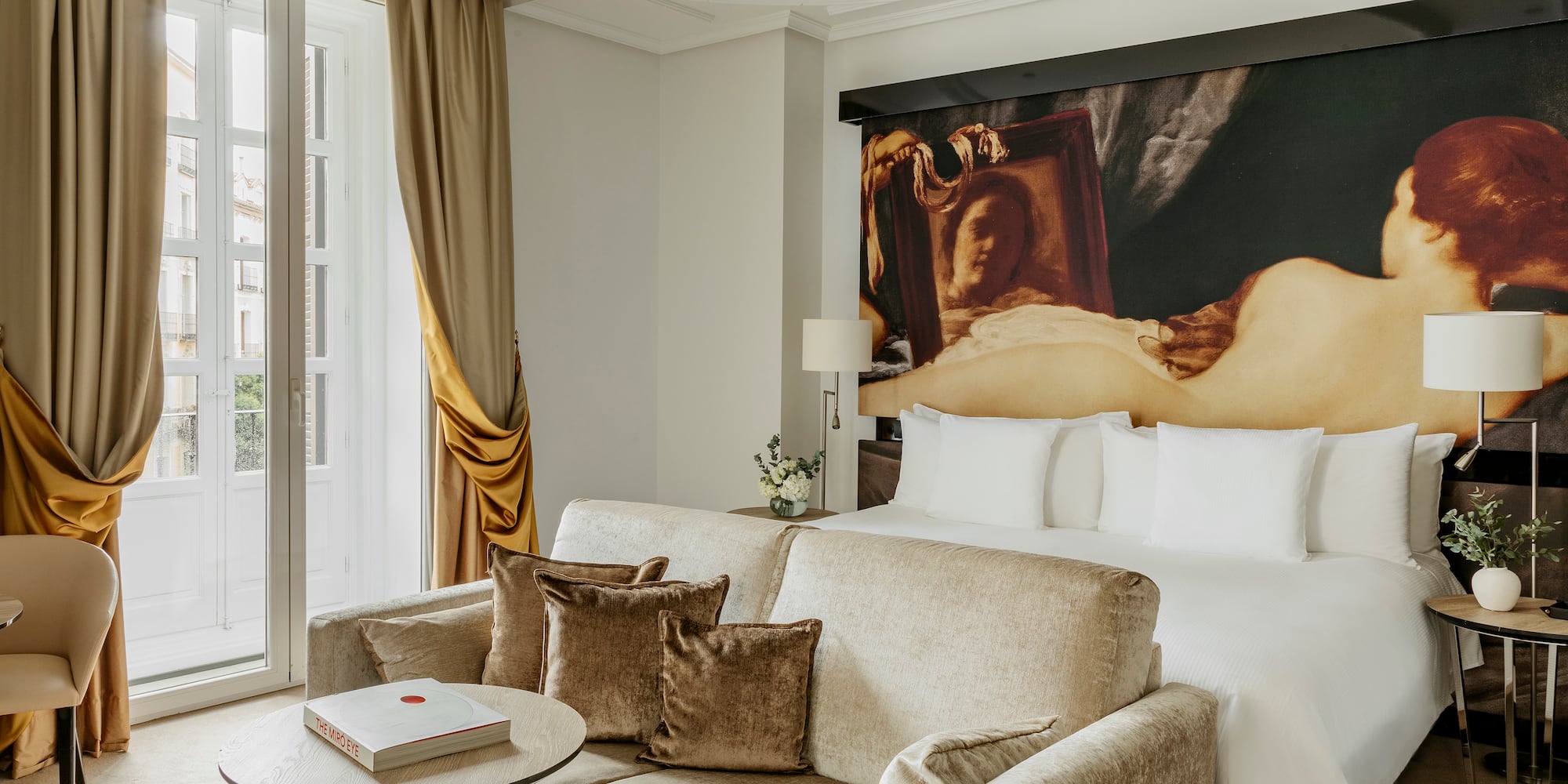 a room with a couch and a painting on the wall