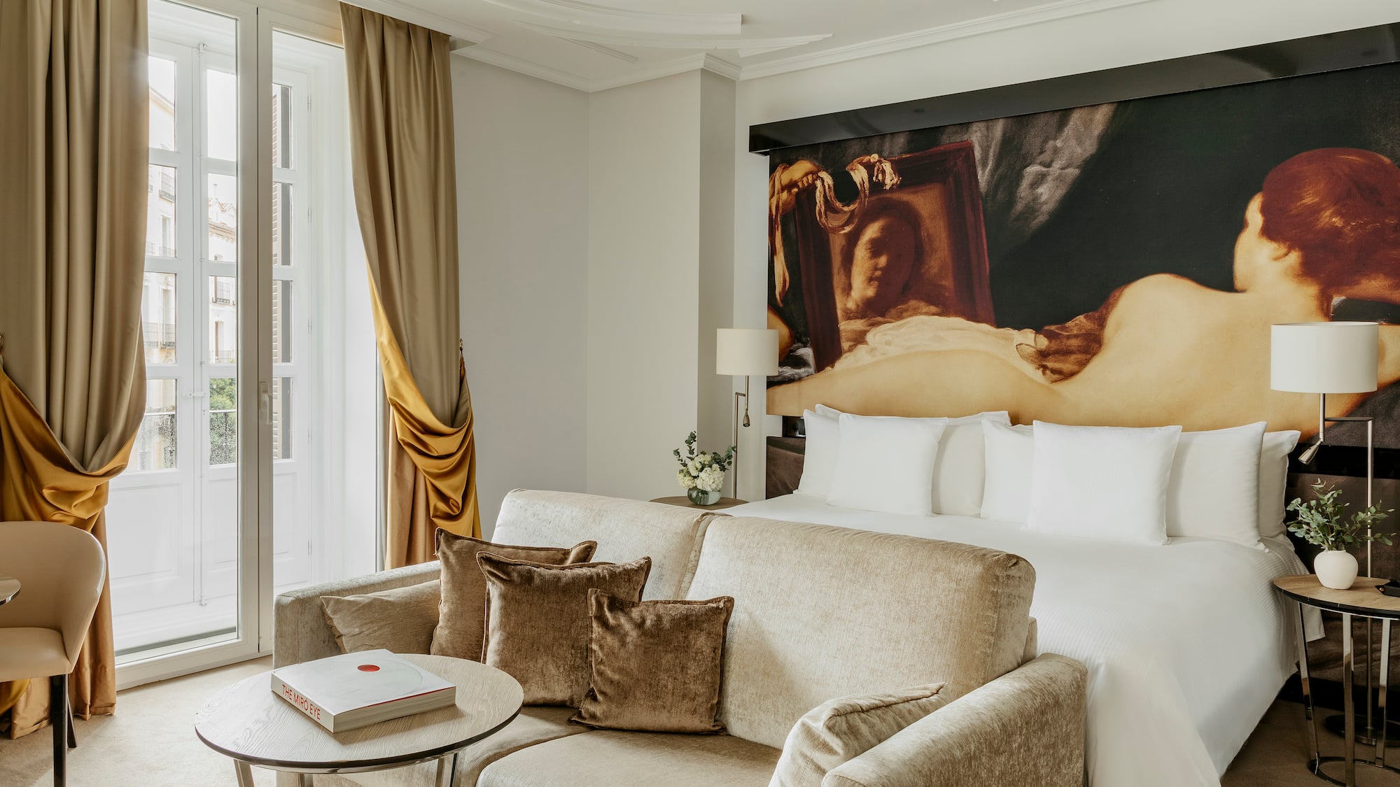 a room with a couch and a painting on the wall