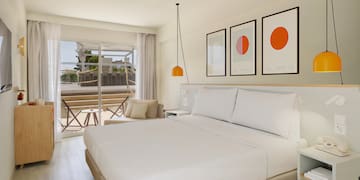 a bedroom with a bed and a glass door