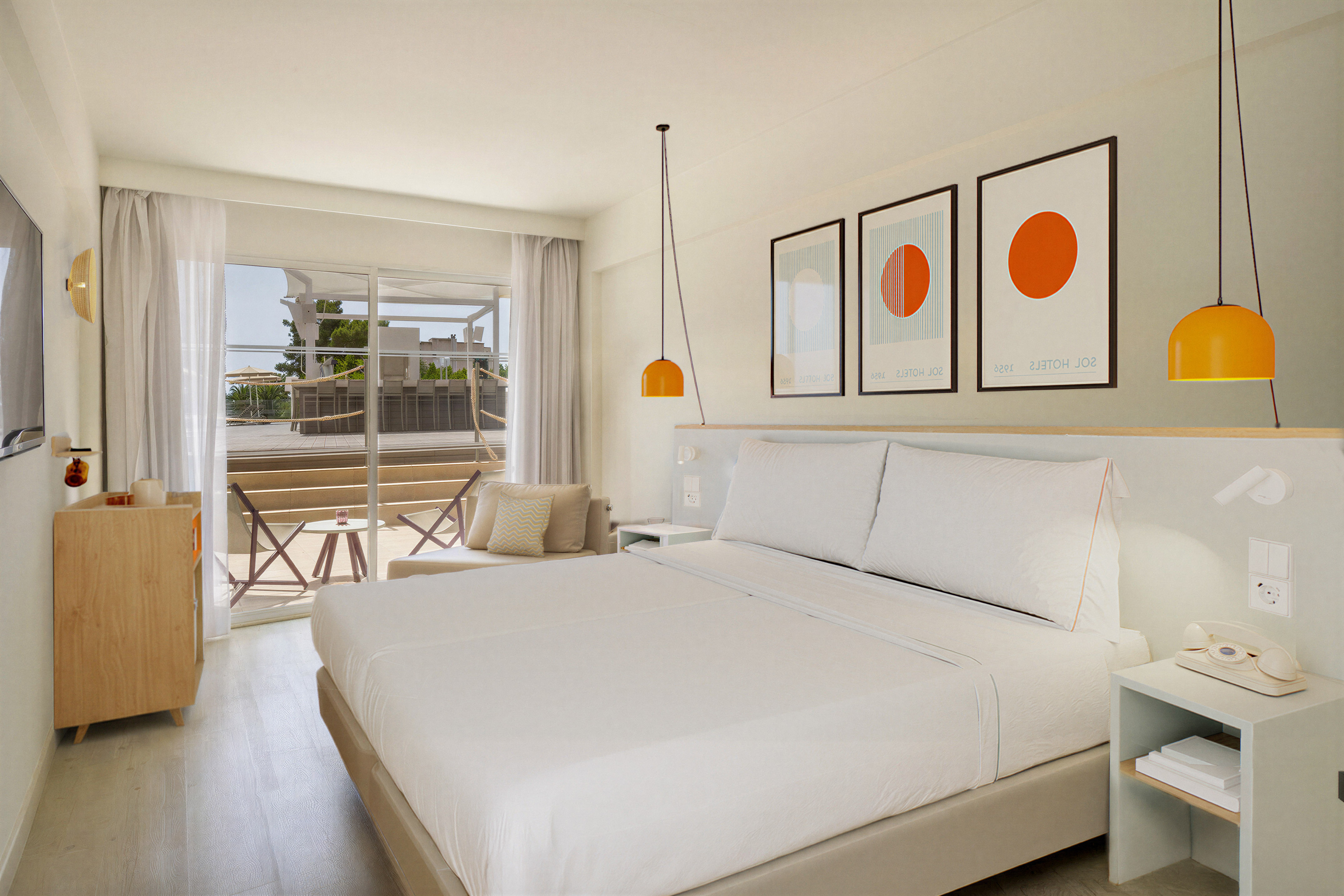 Stylish hotel bedroom with white bed, modern art, and terrace access.