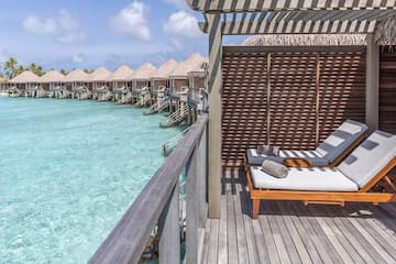 a deck with chairs and a pool of water