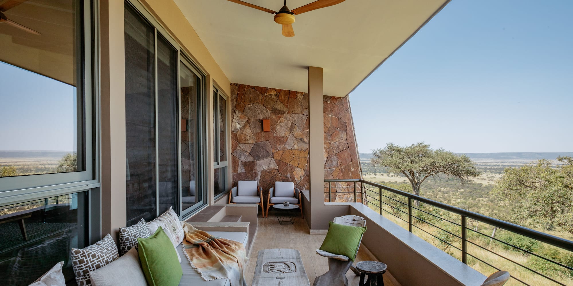 a patio with a fan and furniture