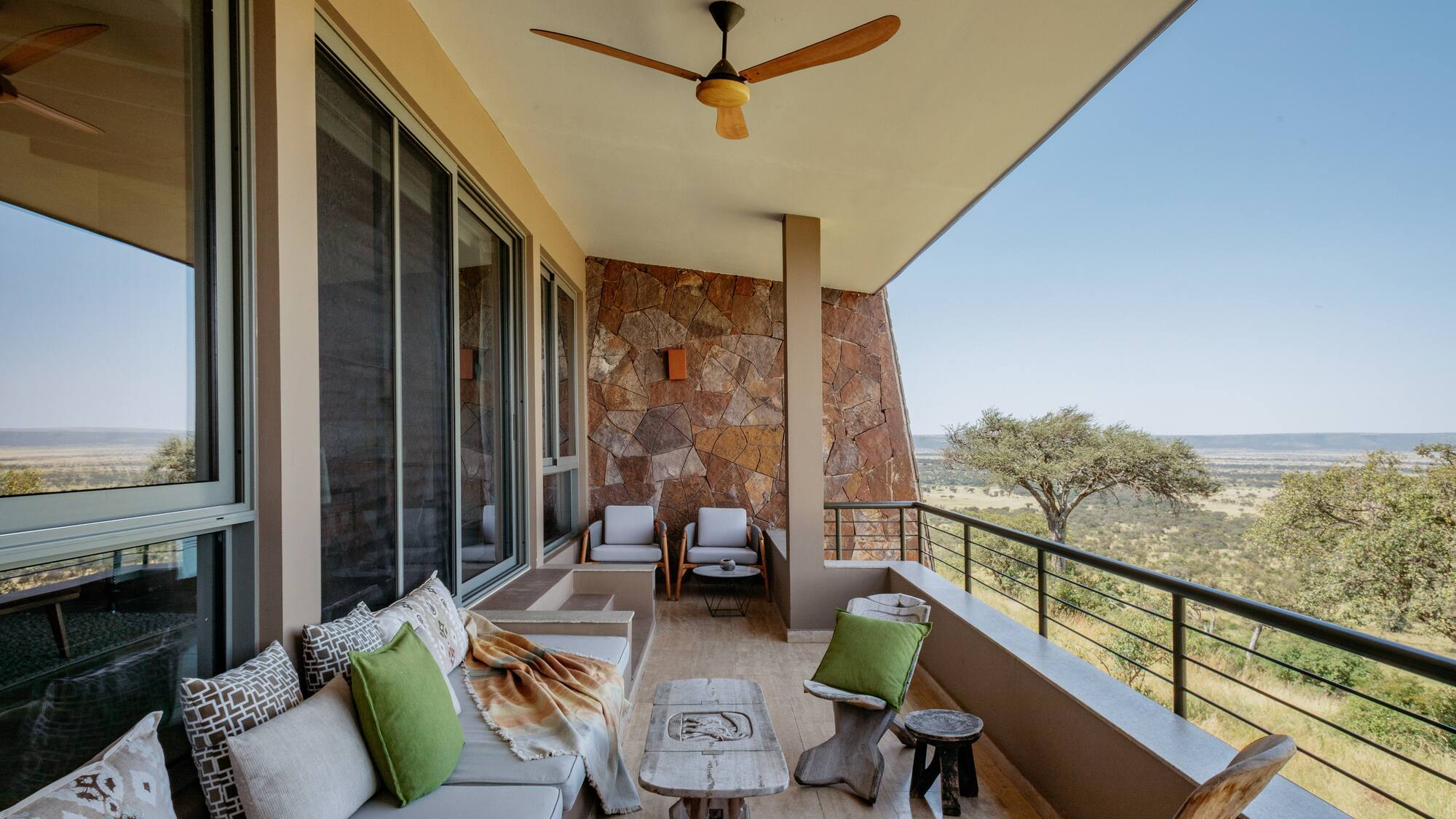 a patio with a fan and furniture