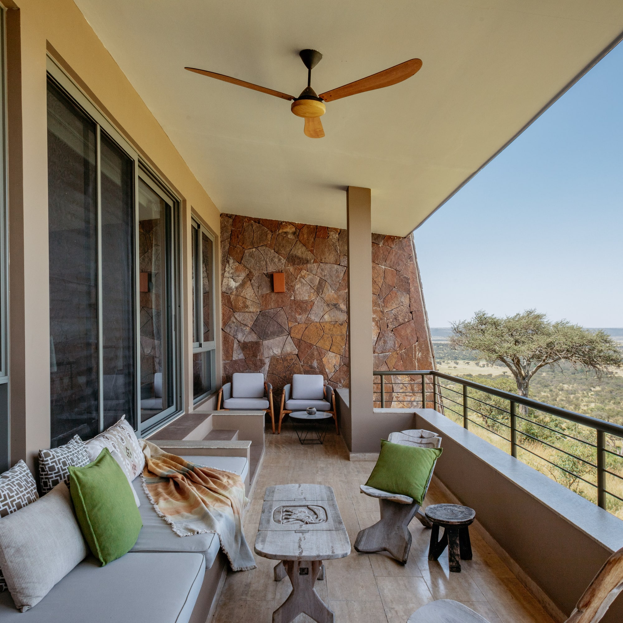 a patio with a fan and furniture