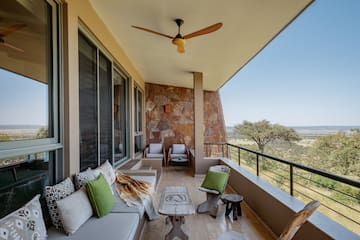 a patio with a fan and furniture