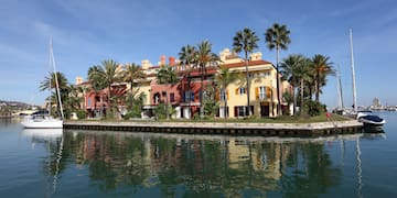 a building with palm trees on the side of it