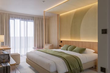 a bedroom with a bed and a wood wall