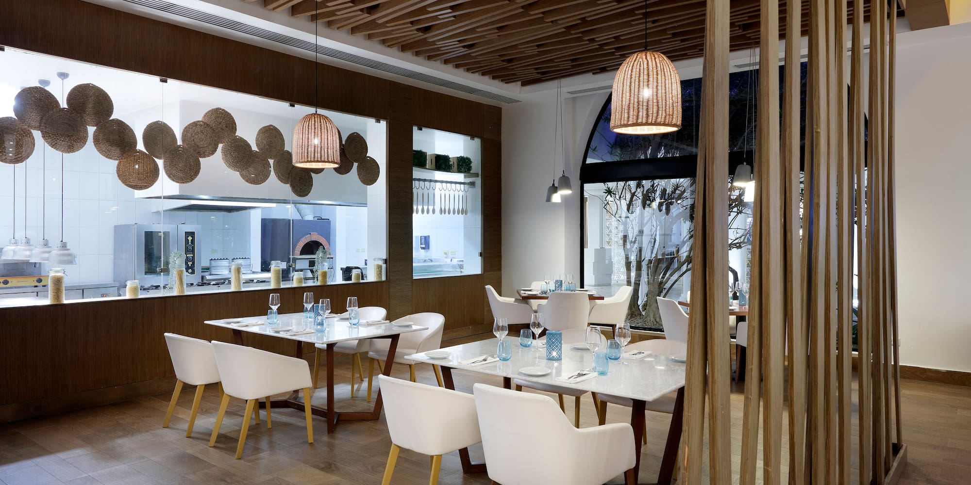 a room with white tables and chairs