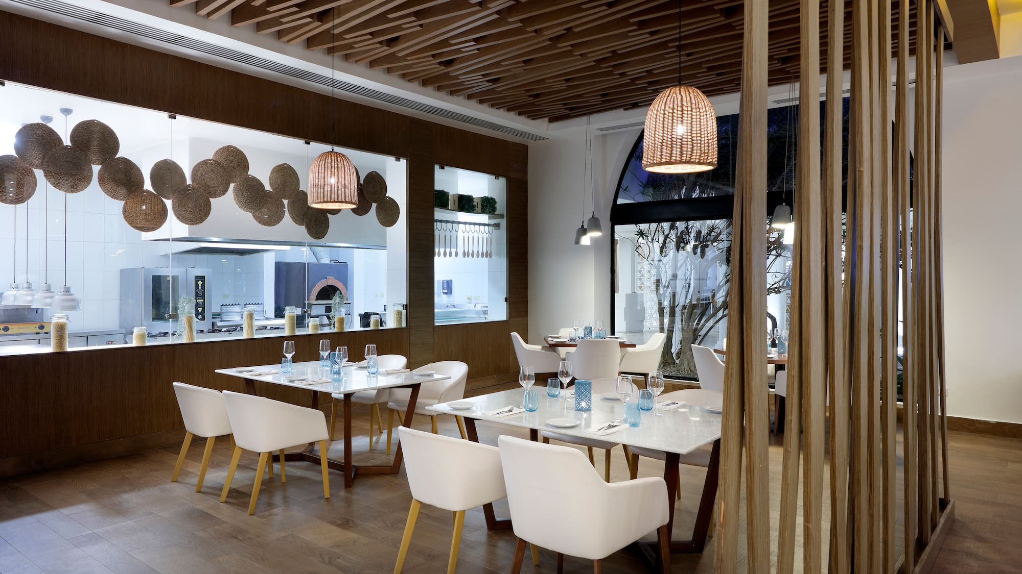 a room with white tables and chairs