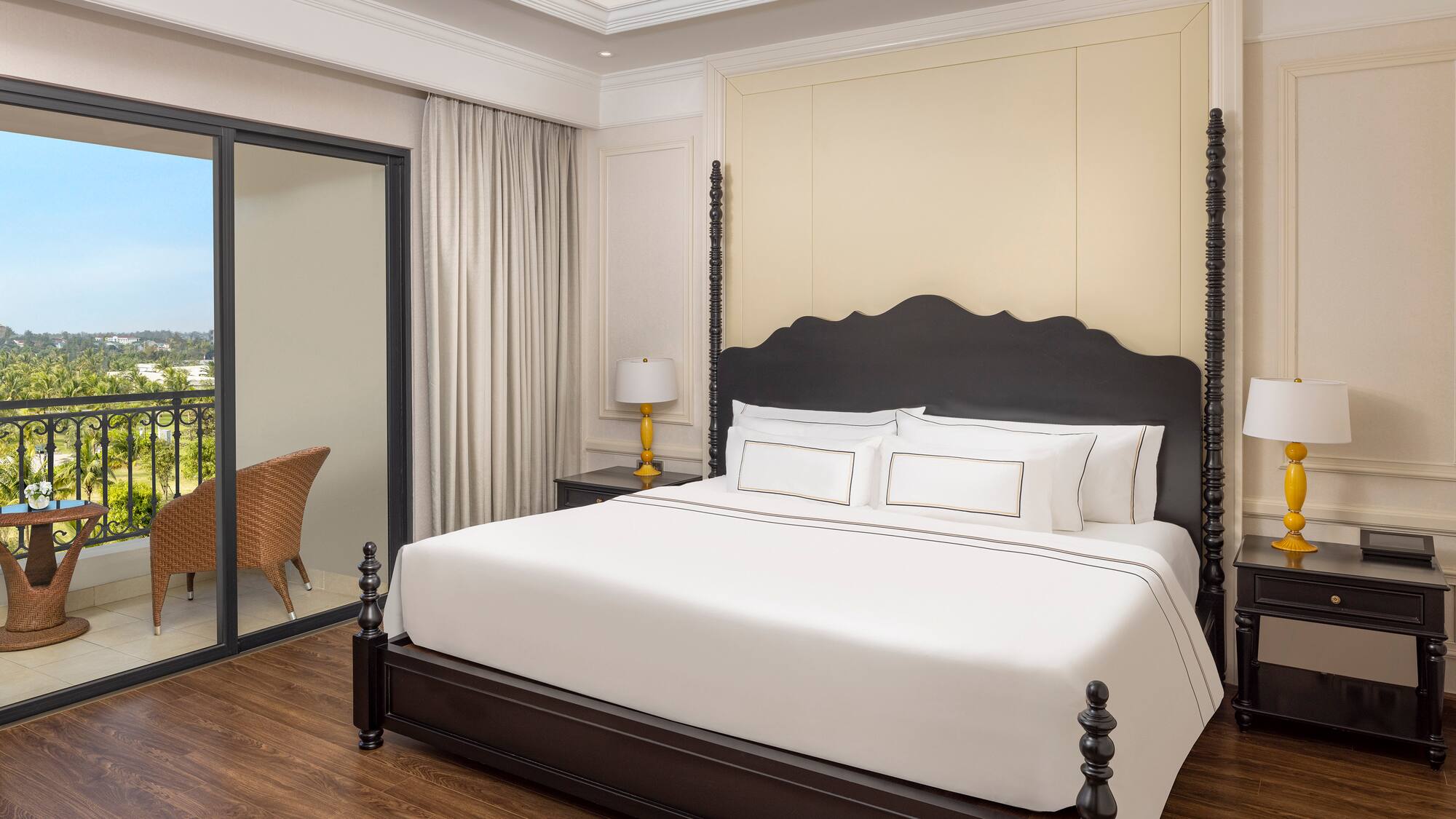 a bed with white sheets and a black headboard