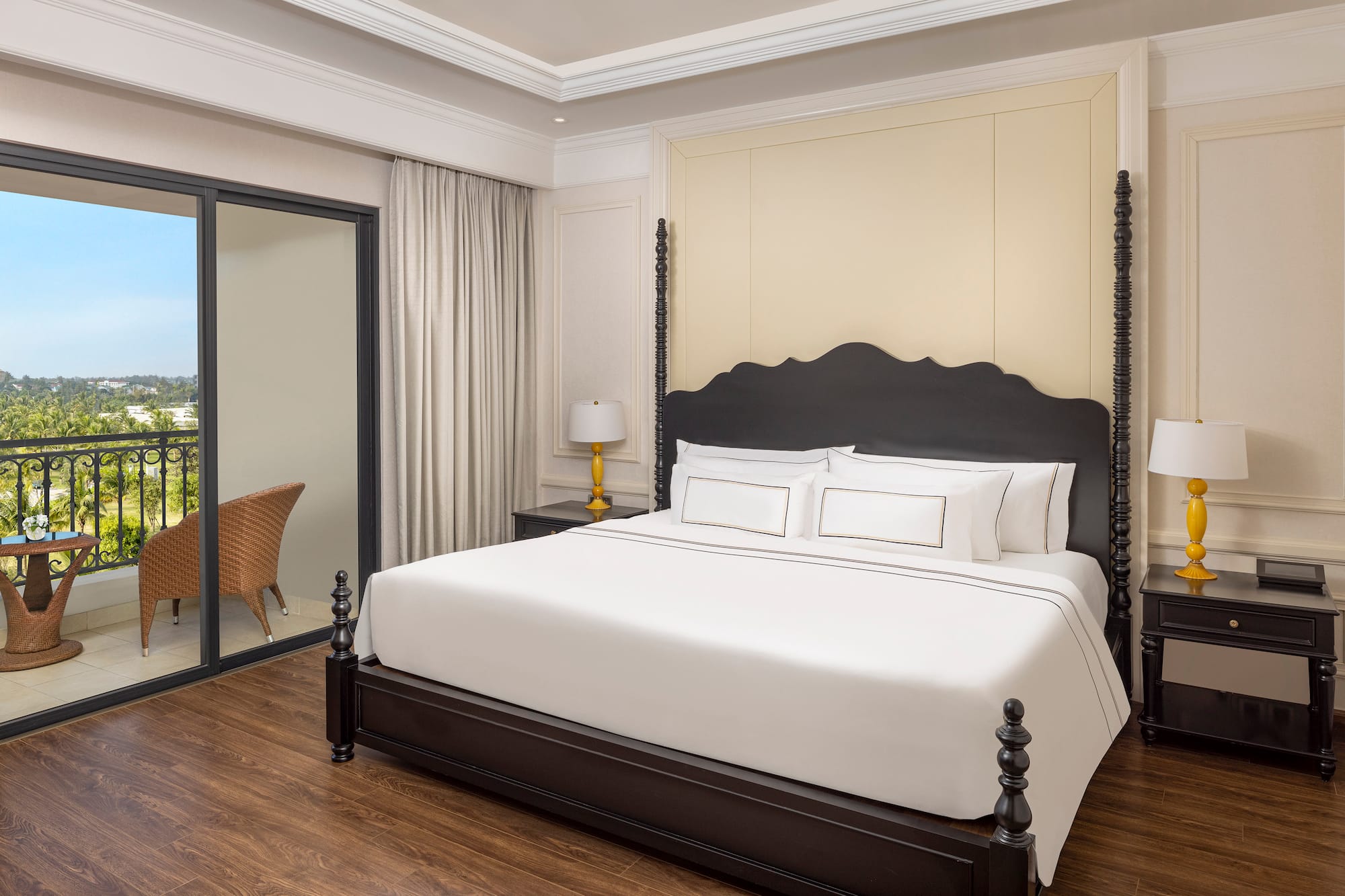 a bed with white sheets and a black headboard