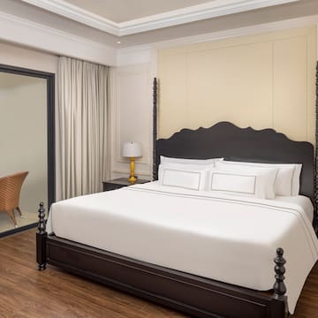 a bed with white sheets and a black headboard