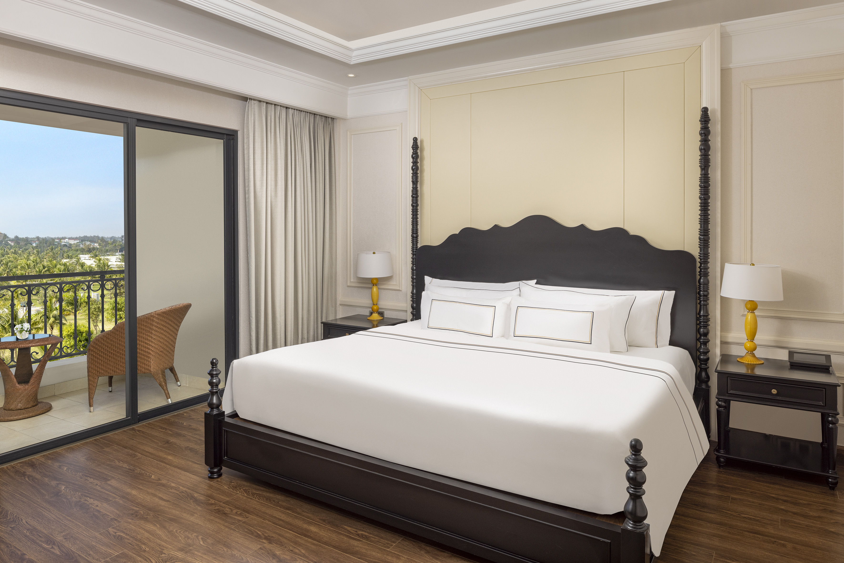 a bed with white sheets and a black headboard
