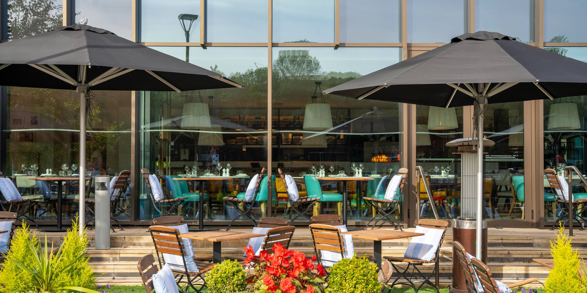 a patio area with chairs and umbrellas
