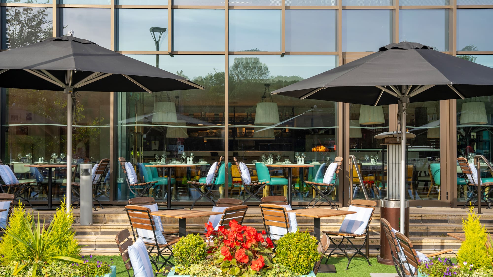 a patio area with chairs and umbrellas