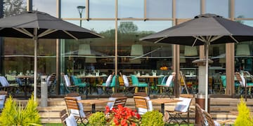 a patio area with chairs and umbrellas