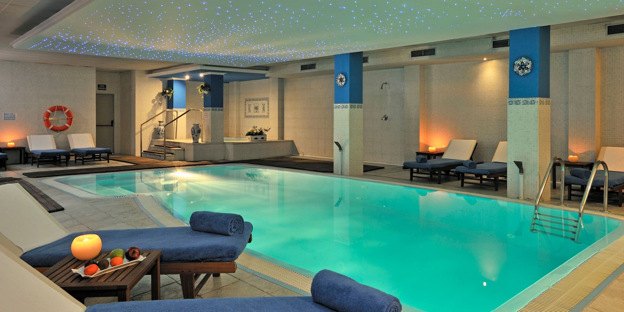 a pool with lounge chairs and a table