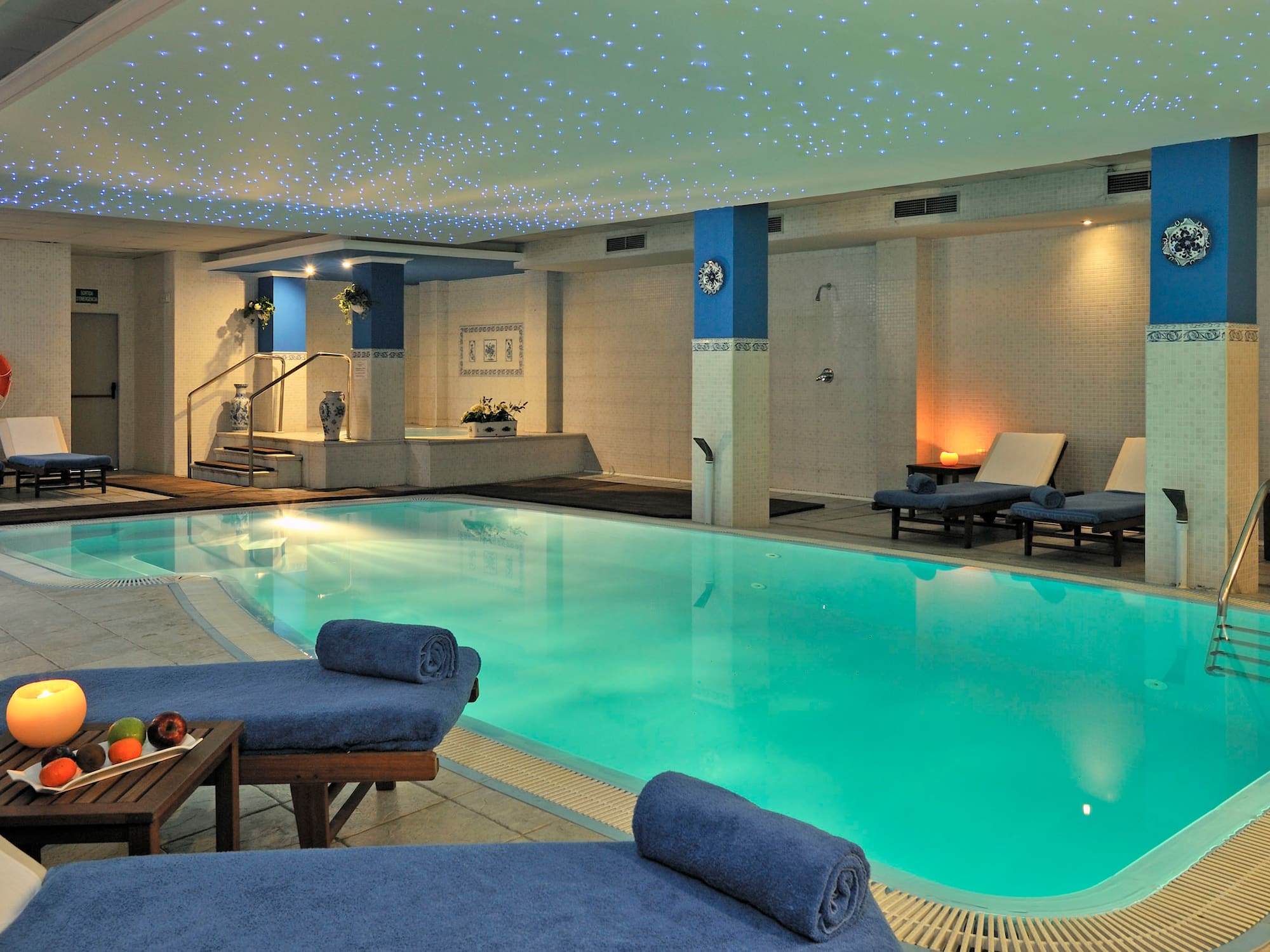 a pool with lounge chairs and a table