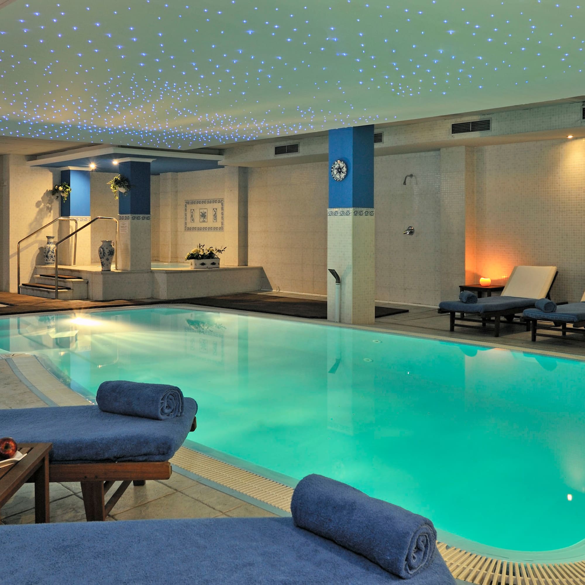 a pool with lounge chairs and a table