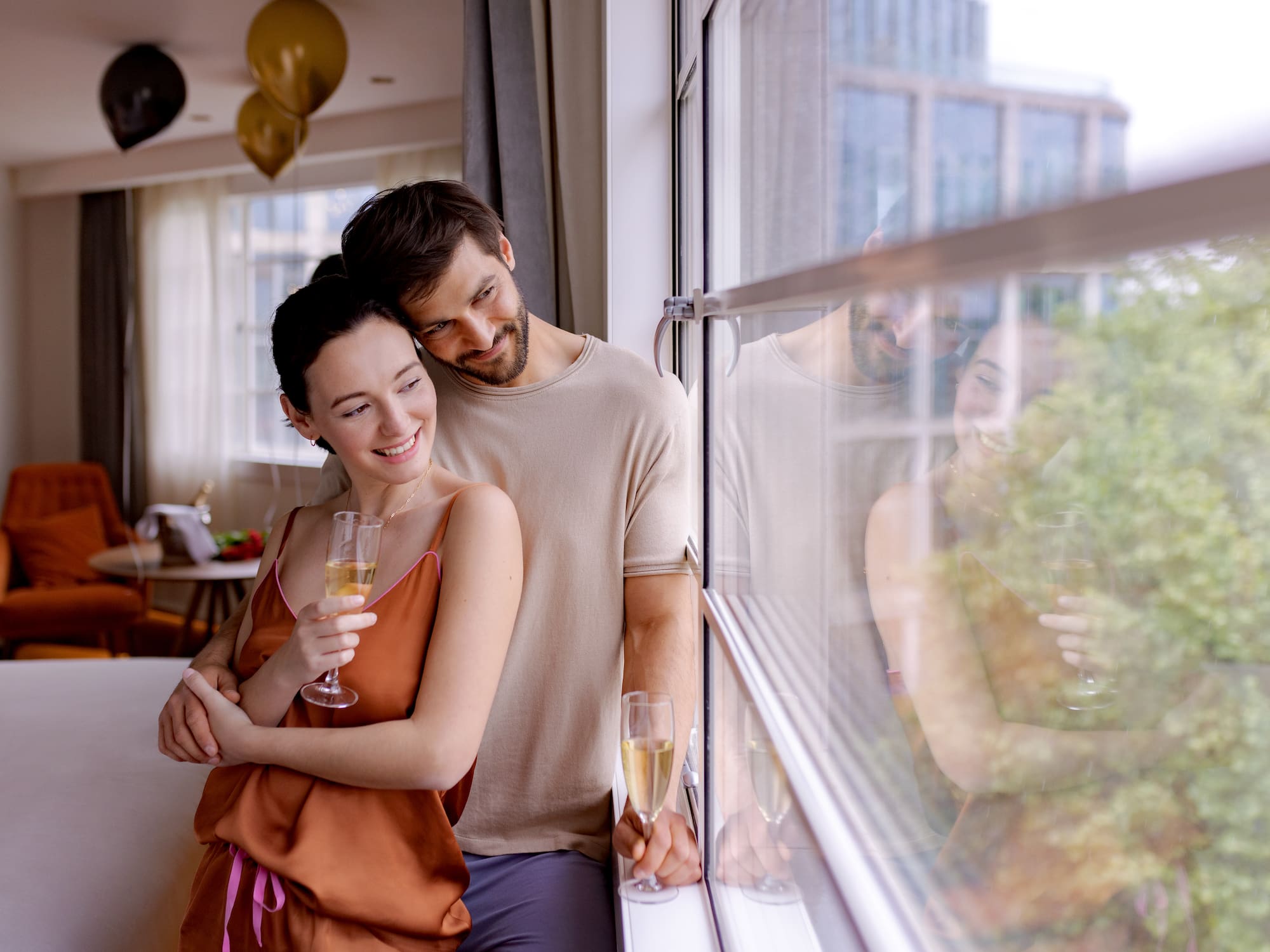 a man and woman holding glasses of champagne