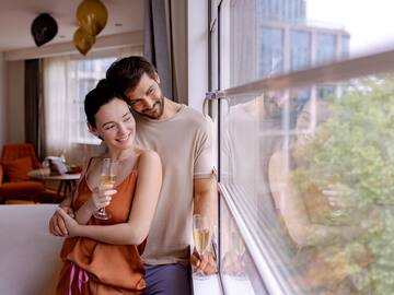 a man and woman holding glasses of champagne