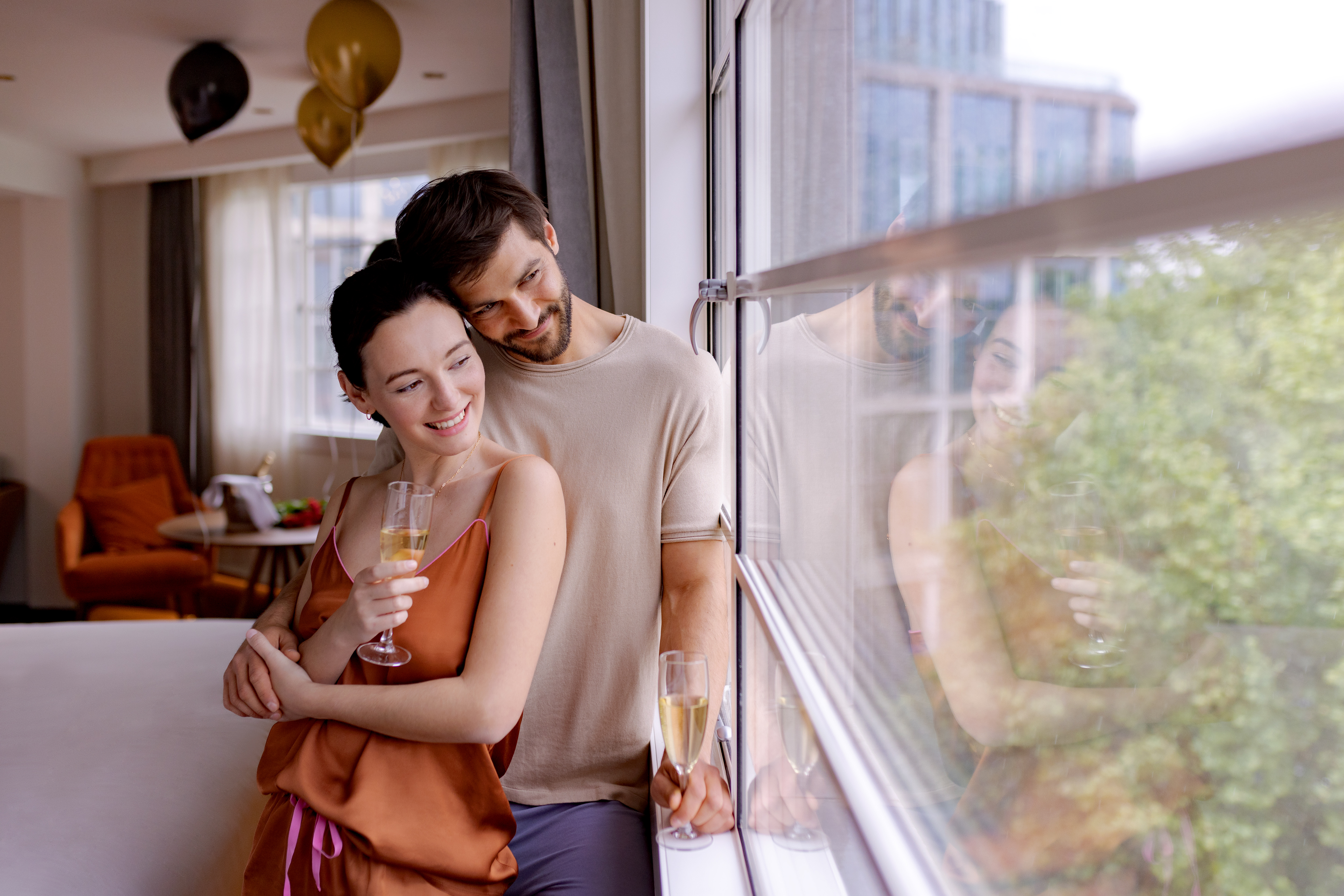 a man and woman holding glasses of champagne