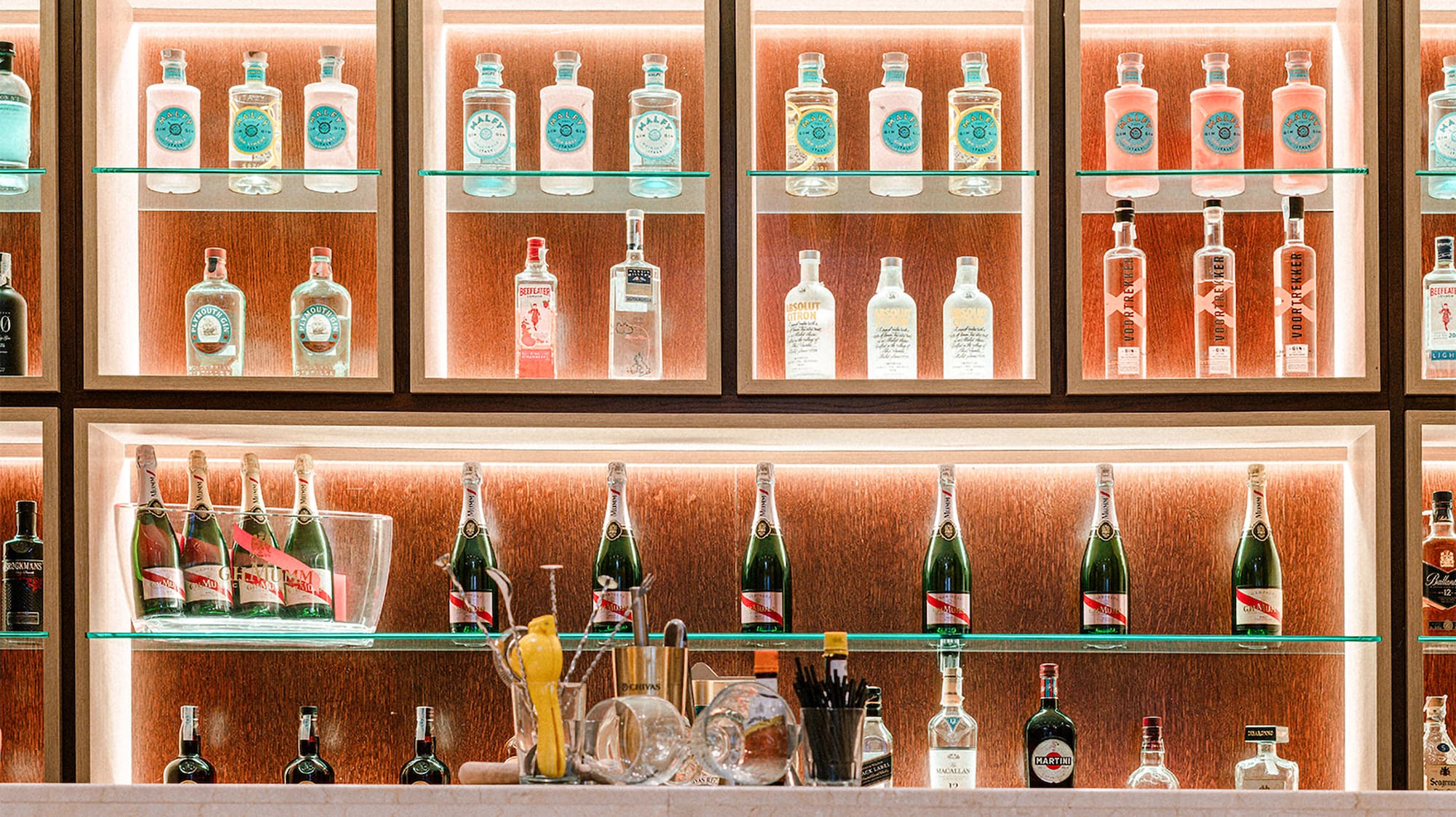 a shelf with bottles of alcohol on it