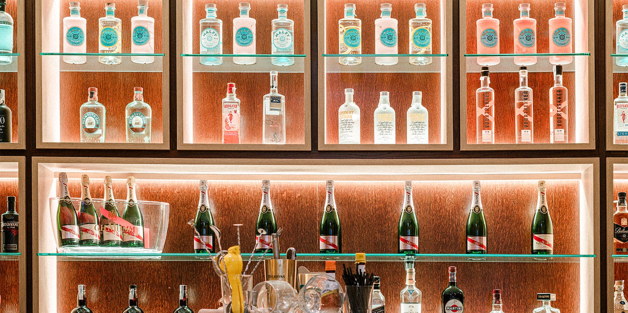 a shelf with bottles of alcohol on it