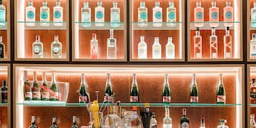 a shelf with bottles of alcohol on it
