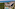 a group of buildings with a pool and trees around it