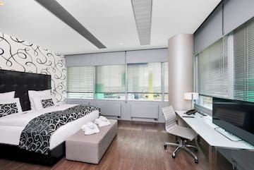 a bedroom with a bed and a desk