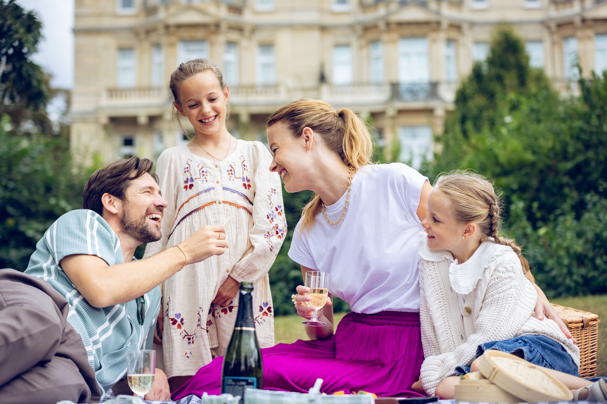 a group of people sitting on a picnic blanket
