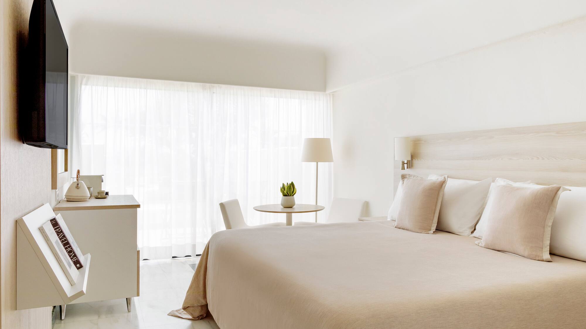 a bedroom with a bed and a table