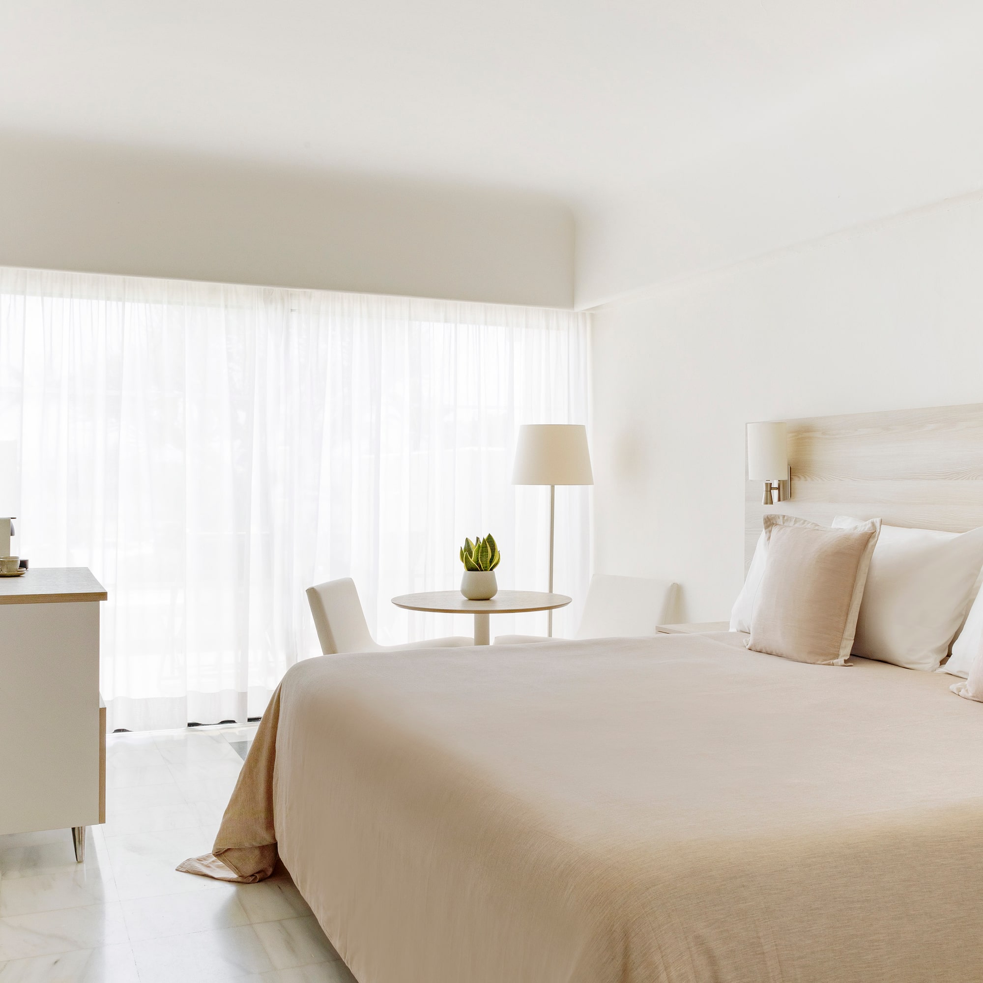 a bedroom with a bed and a table