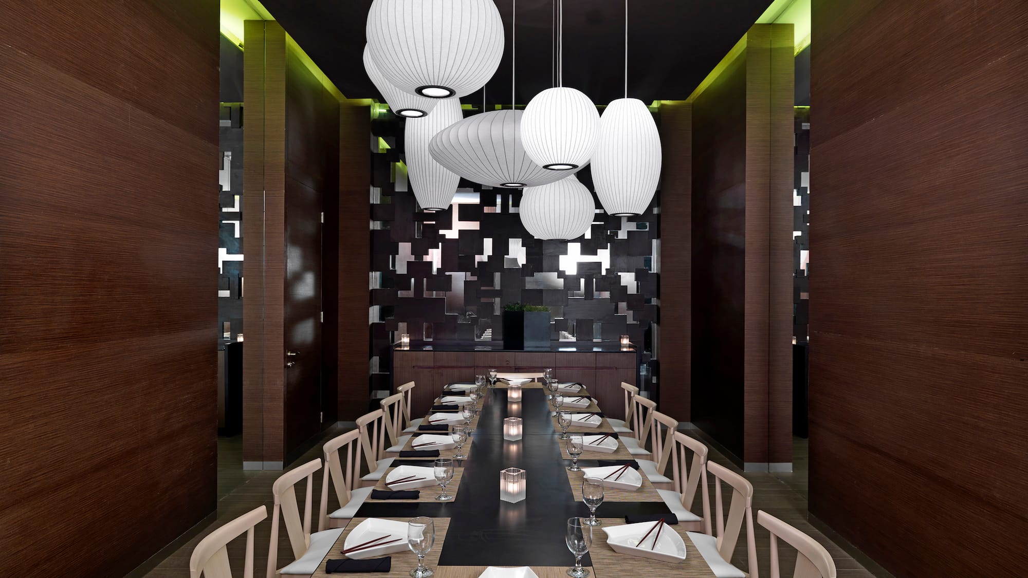 a long table with chairs and plates in a room